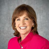 Headshot of Dean Lorraine Frazier wearing bright pink blazer.